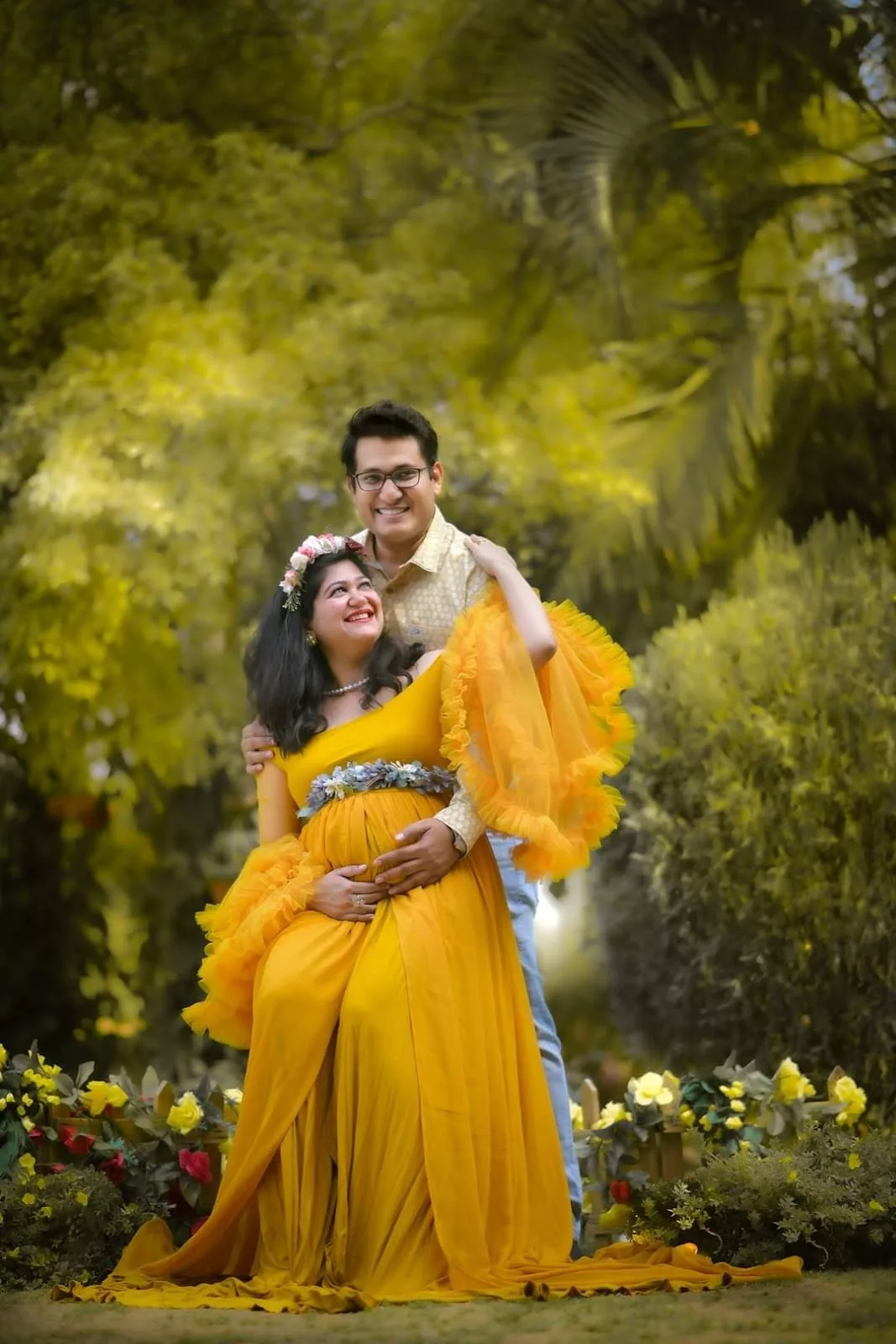 Expectant parents sharing a golden maternity portrait outdoors