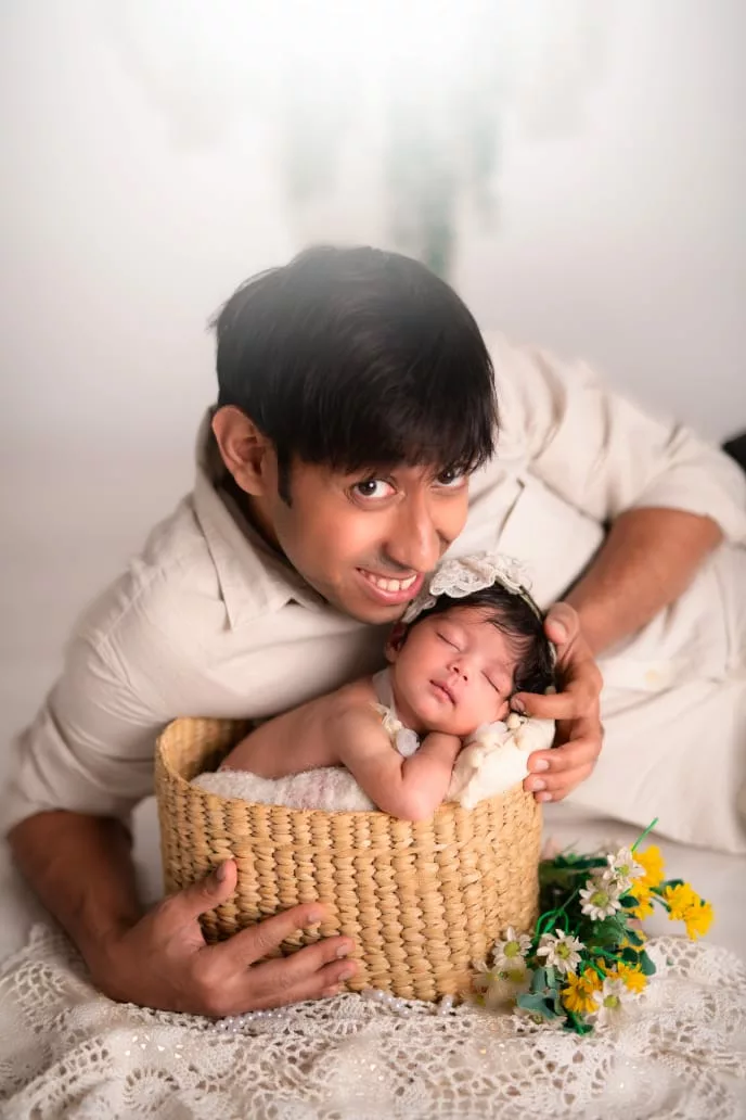 Father holding his sleeping newborn
